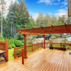 A beautifully crafted wooden deck overlooking a lush backyard