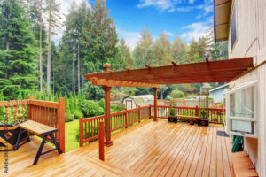 A beautifully crafted wooden deck overlooking a lush backyard Custom Deck Installation